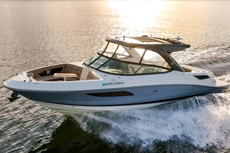 Slide: The Image of 2016 Sea Ray SLX 350 cruising on water at sunset, showcasing sleek design and performance. - 8
