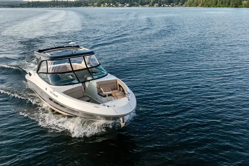 Slide: The Image of 2016 Sea Ray SLX 350 cruising on a serene lake with scenic shoreline. - 7