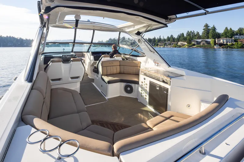 Slide: The Image of Luxurious 2016 Sea Ray SLX 350 boat interior with spacious seating on a serene lake. - 19