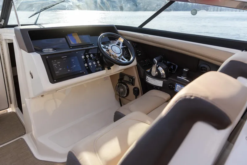 Slide: The Image of 2016 Sea Ray SLX 350 helm with modern controls and navigation system. - 12