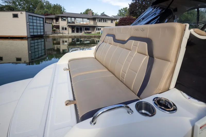 Slide: The Image of 2016 Sea Ray SLX 350 boat with luxurious seating, docked near waterfront homes. - 25