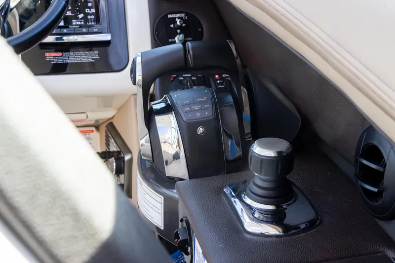 Slide: The Image of Control panel of a 2016 Sea Ray SLX 350 boat, featuring throttle and joystick. - 14