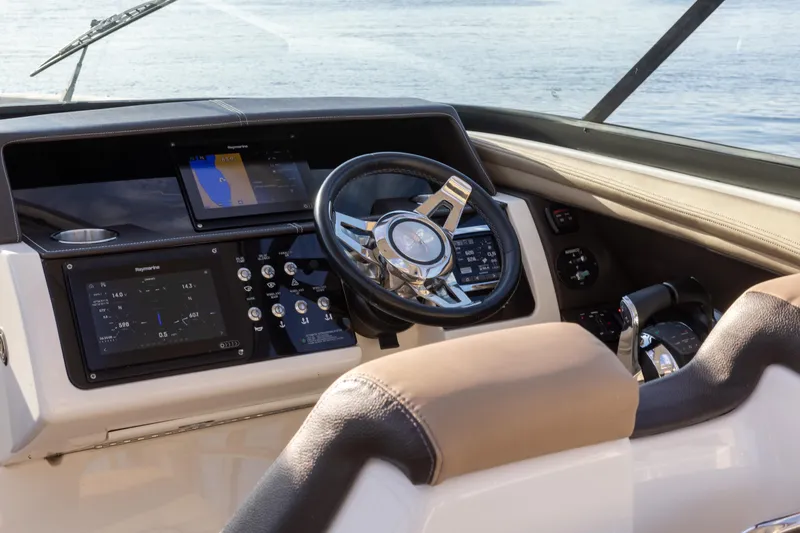 Slide: The Image of 2016 Sea Ray SLX 350 helm with modern navigation controls and steering wheel. - 13