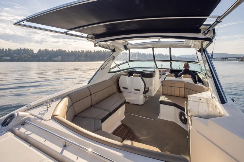 Slide: The Image of 2016 Sea Ray SLX 350 boat interior with spacious seating and scenic water view. - 29