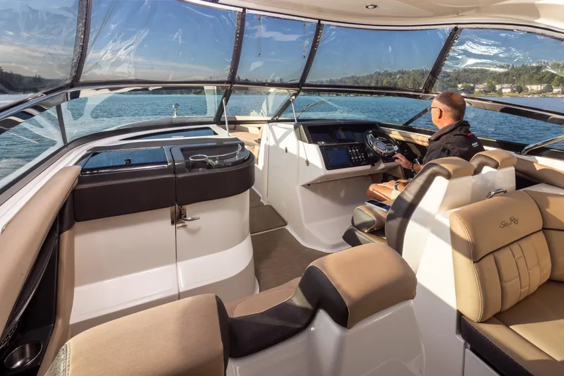 Slide: The Image of 2016 Sea Ray SLX 350 boat interior with driver, featuring luxurious seating and modern controls. - 15