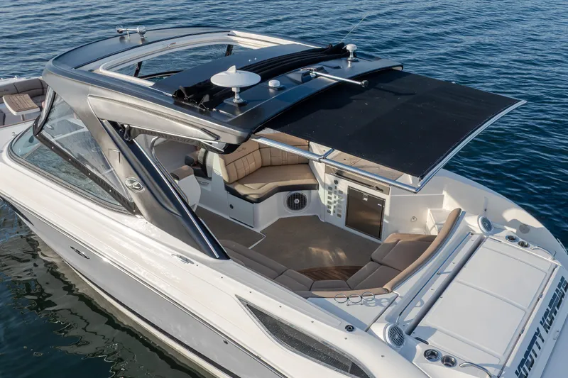 Slide: The Image of 2016 Sea Ray SLX 350 boat with spacious seating and sleek design on calm water. - 6