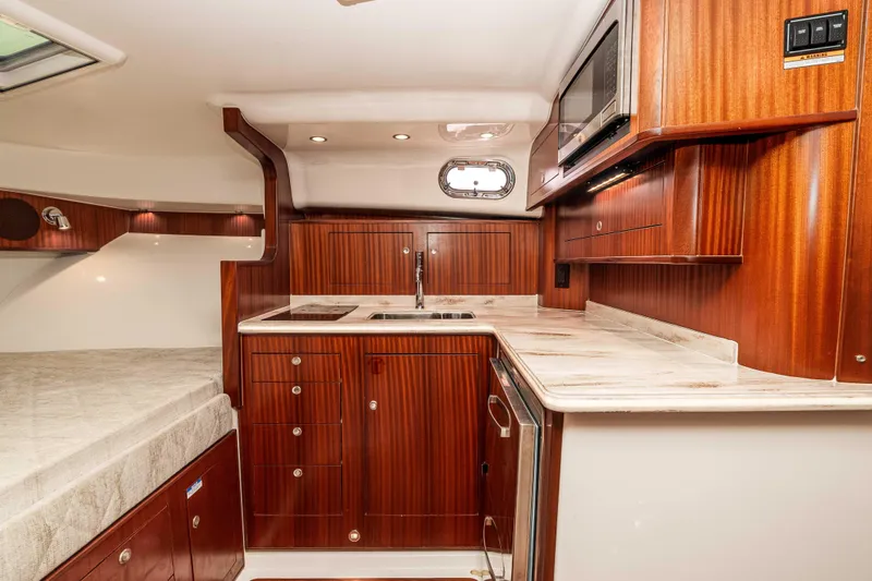 Slide: The Image of Luxurious 2022 Pursuit OS 385 Offshore yacht interior with elegant wood cabinetry and modern amenities. - 30