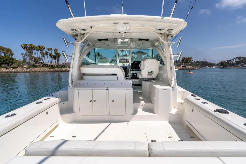 Slide: The Image of 2022 Pursuit OS 385 Offshore boat interior with seating, ocean view, and clear sky. - 9