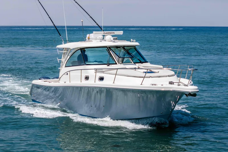 Slide: The Image of 2022 Pursuit OS 385 Offshore boat cruising on open water. - 5