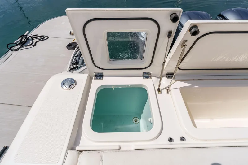 Slide: The Image of 2022 Pursuit OS 385 Offshore boat with open storage compartments on deck. - 23