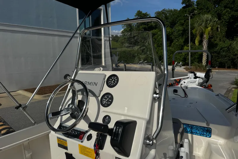 Slide: The Image of 2023 Key West 1720 Center Console boat interior with steering wheel and gauges. - 4