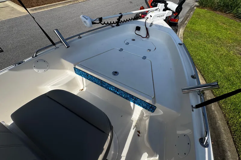 Slide: The Image of 2023 Key West 1720 Center Console boat interior with seating and storage compartments. - 9