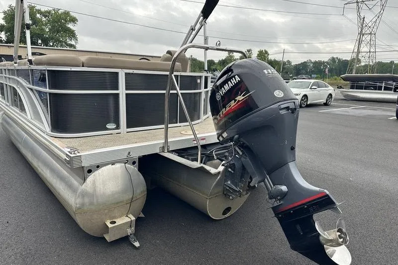 Slide: The Image of 2019 Bennington 20 SLM pontoon boat with Yamaha outboard motor in parking lot. - 16