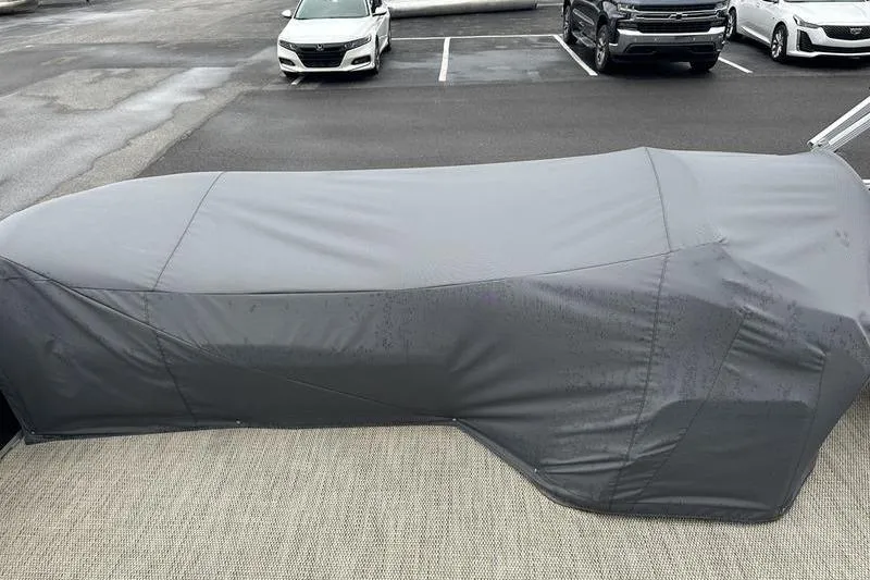 Slide: The Image of Covered 2019 Bennington 20 SLM boat in parking lot, gray protective cover. - 5