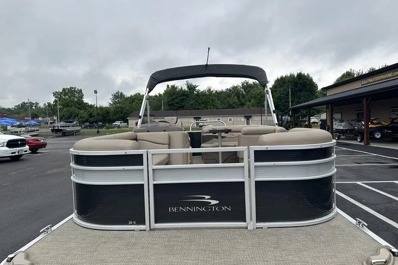 Slide: The Image of 2019 Bennington 20 SLM pontoon boat in a parking lot, overcast sky. - 8