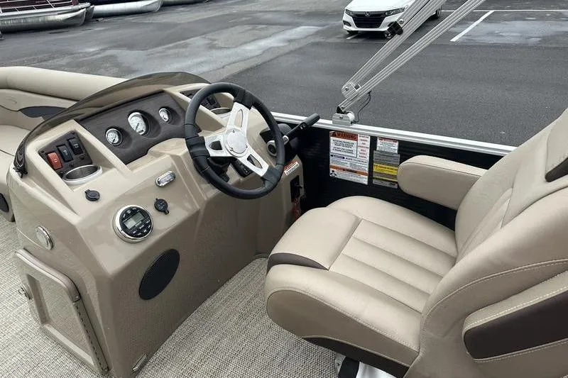 Slide: The Image of Interior view of a 2019 Bennington 20 SLM boat, featuring steering console and captain's chair. - 23