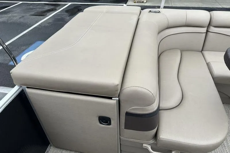 Slide: The Image of 2019 Bennington 20 SLM boat interior with beige seating and cup holder. - 14