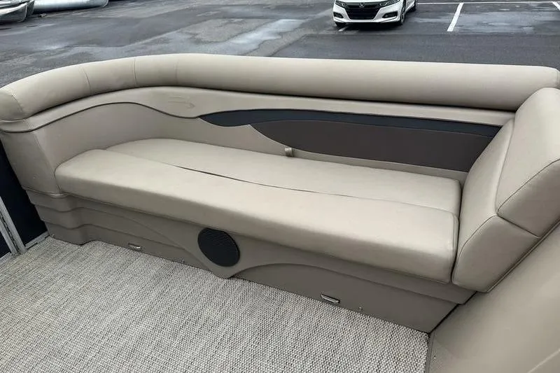 Slide: The Image of 2019 Bennington 20 SLM pontoon boat interior with beige seating and carpeted flooring. - 19