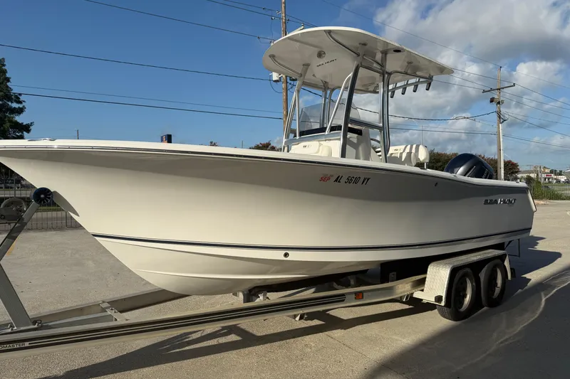 Slide: The Image of 2015 Sea Hunt Triton 225 boat on trailer under clear blue sky. - 5
