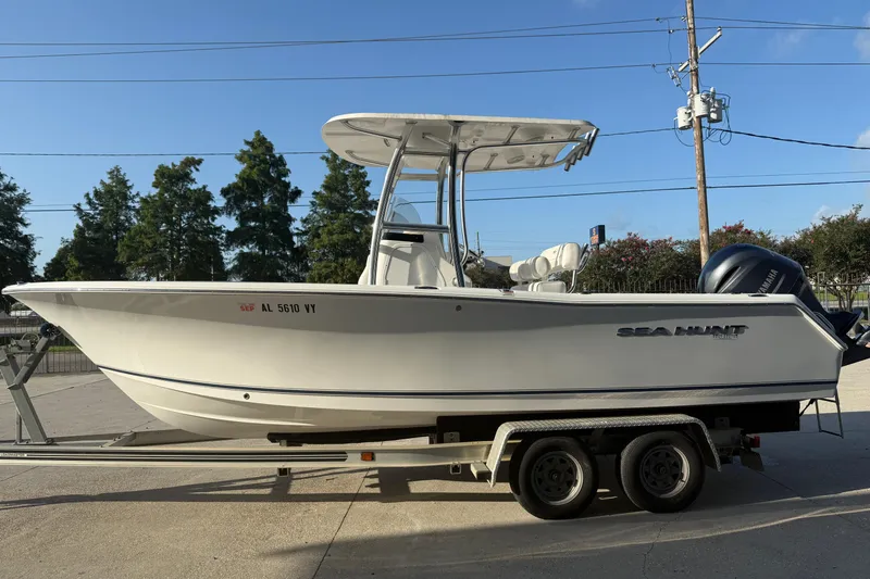Slide: The Image of 2015 Sea Hunt Triton 225 boat on trailer, side view, clear sky background. - 6