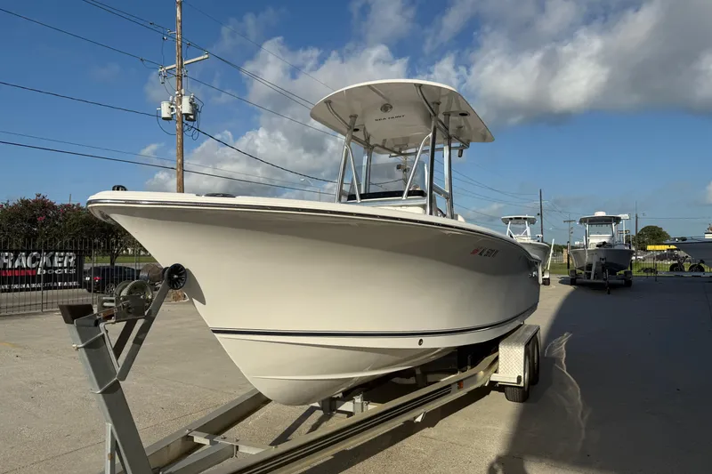 Slide: The Image of 2015 Sea Hunt Triton 225 boat on trailer under clear blue sky. - 4