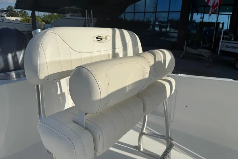Slide: The Image of White leather seating on a 2015 Sea Hunt Triton 225 boat, featuring sleek design. - 12