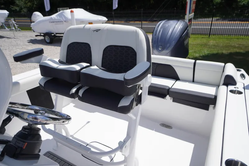 Slide: The Image of 2026 Tidewater 232 LXF boat interior with dual seats and steering wheel. - 40