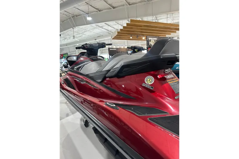 Slide: The Image of 2019 Yamaha WaveRunner VX Limited in showroom, featuring sleek red design and comfortable seating. - 18