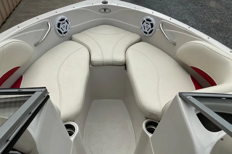 Slide: The Image of Interior of a 2014 Tahoe Q7i boat with white cushioned seating and speakers. - 6