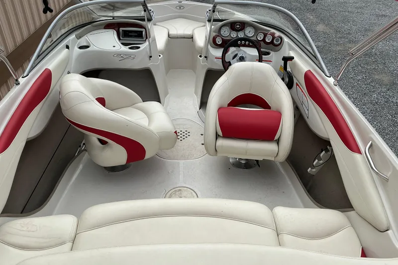 Slide: The Image of 2014 Tahoe Q7i boat interior with white and red seating, steering wheel, and dashboard. - 3