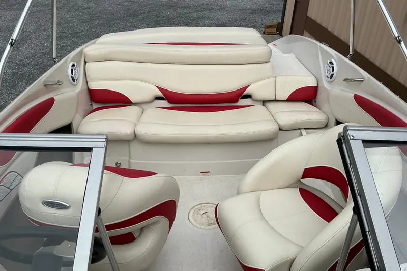 Slide: The Image of 2014 Tahoe Q7i boat interior with white and red seating arrangement. - 7