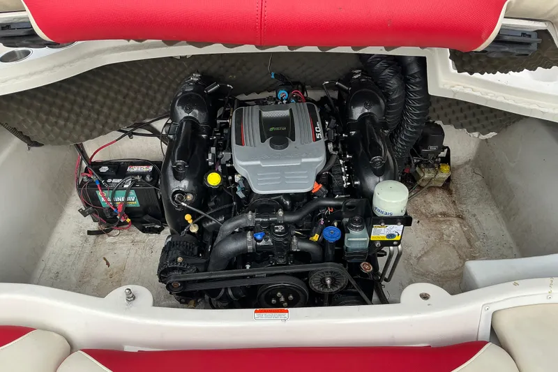 Slide: The Image of Engine compartment of a 2014 Tahoe Q7i boat, featuring a 5.0L engine and battery. - 9