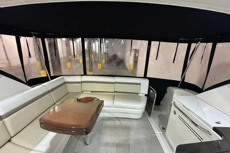 Slide: The Image of Interior of 2014 Sea Ray 410 Sundancer yacht with seating and table. - 2