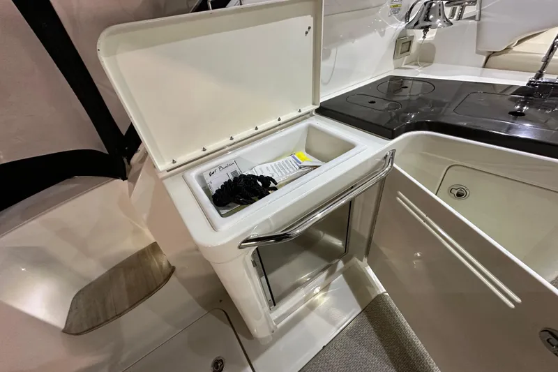 Slide: The Image of Interior of 2014 Sea Ray 410 Sundancer yacht with open storage compartment. - 9