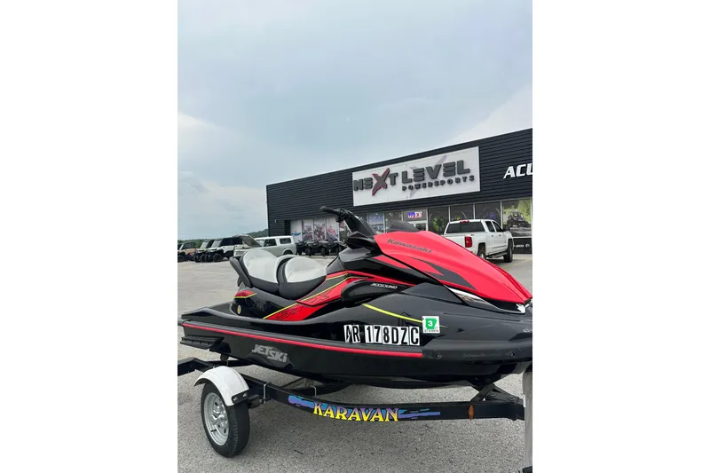 Slide: The Image of 2024 Kawasaki Jetski STX 160LX on trailer outside dealership, showcasing sleek design. - 5