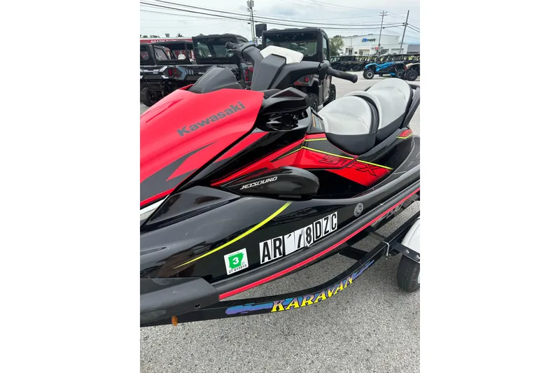 Slide: The Image of 2024 Kawasaki Jetski STX 160LX in vibrant red and black on a trailer. - 8