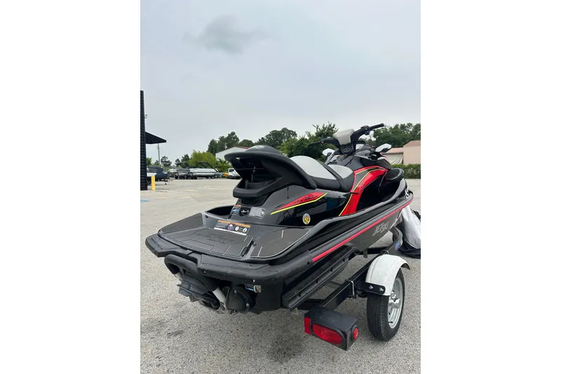 Slide: The Image of 2024 Kawasaki Jetski STX 160LX on trailer, parked outdoors, showcasing sleek design. - 3