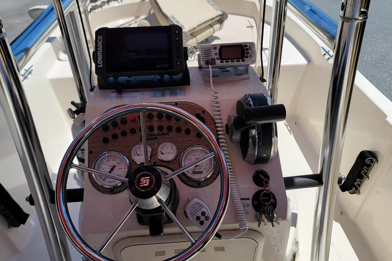 Slide: The Image of 2021 Carolina Skiff 178 JLS boat console with steering wheel and navigation equipment. - 5
