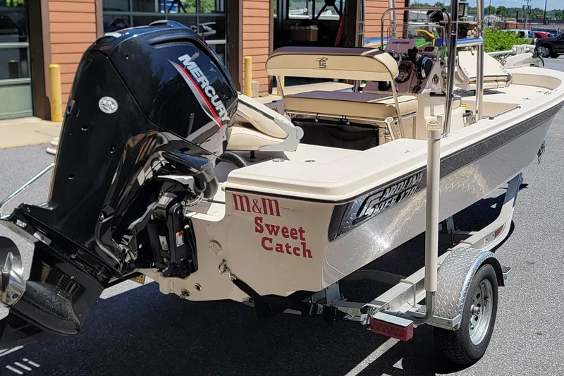 Slide: The Image of 2021 Carolina Skiff 178 JLS boat with Mercury engine on trailer, labeled "Sweet Catch." - 2