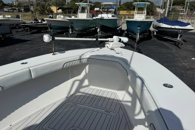 Slide: The Image of 2018 Jupiter 25 Bay boat interior with multiple boats in the background. - 5