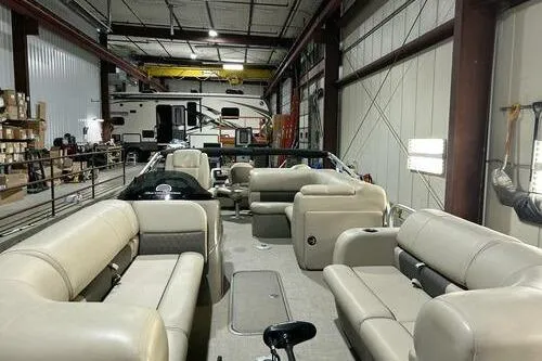 Slide: The Image of 2022 Sun Tracker SportFish 22 XP3 pontoon boat in a warehouse setting. - 5