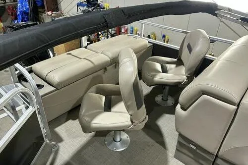 Slide: The Image of 2022 Sun Tracker SportFish 22 XP3 interior with beige seating and modern design. - 9