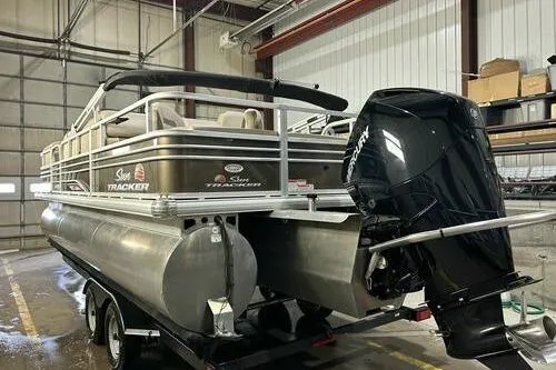 Slide: The Image of 2022 Sun Tracker SportFish 22 XP3 pontoon boat in a warehouse setting. - 4