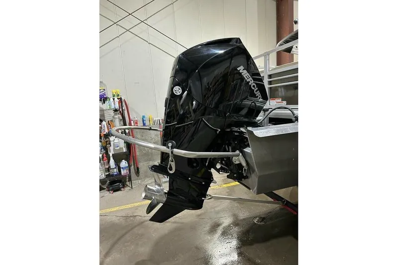 Slide: The Image of Mercury outboard motor on 2022 Sun Tracker SportFish 22 XP3 in a garage setting. - 12