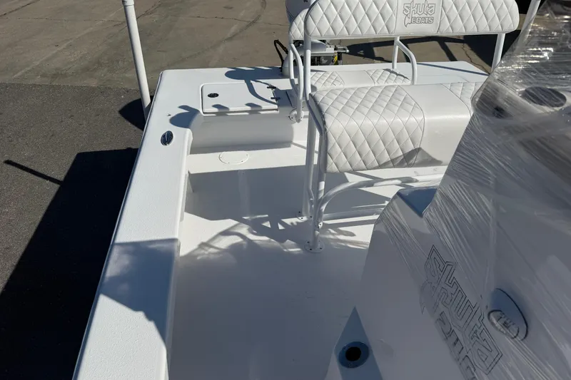 Slide: The Image of 2026 Skuta 24 Cat boat interior with quilted seating and sleek design. - 46