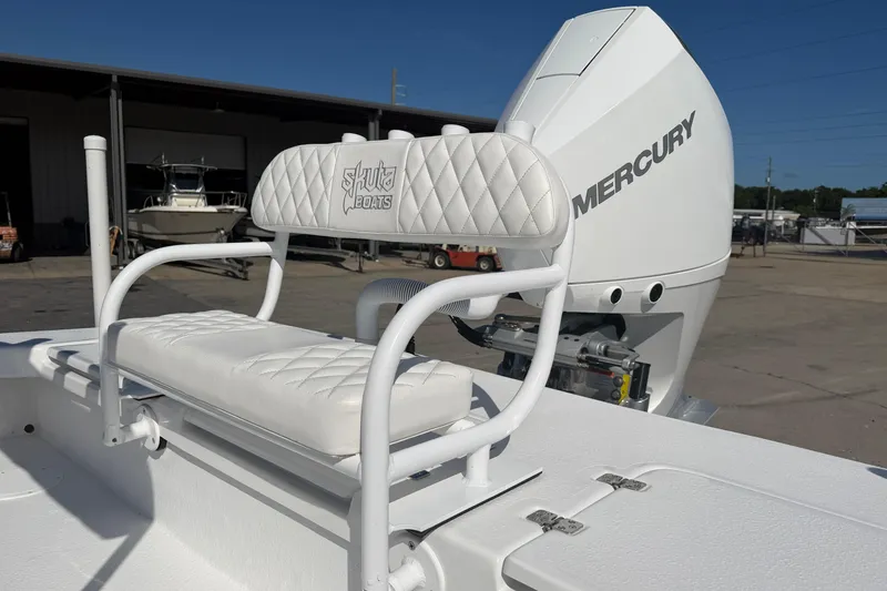 Slide: The Image of 2026 Skuta 24 Cat boat with Mercury engine, featuring white cushioned seating. - 30