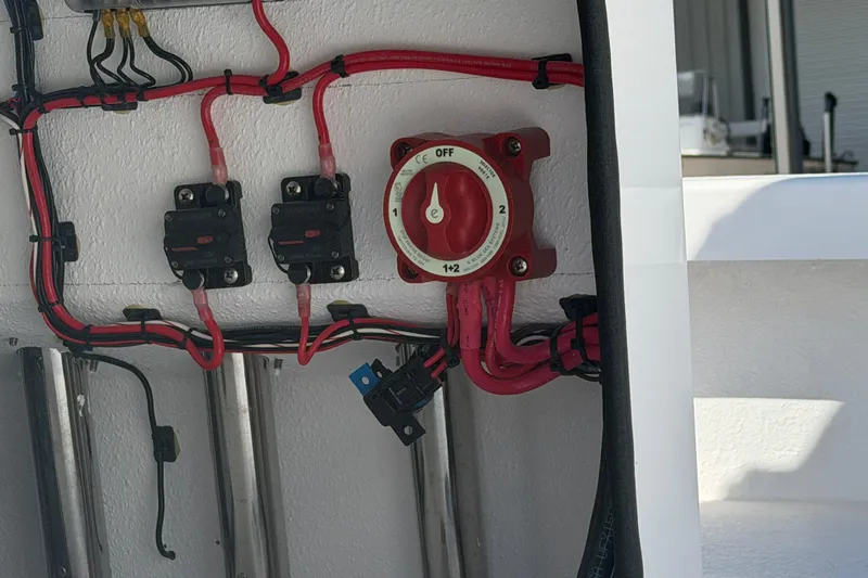 Slide: The Image of Electrical wiring and switch panel on a 2026 Skuta 24 Cat boat. - 29