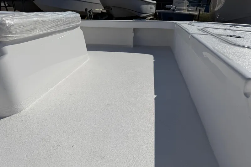 Slide: The Image of 2026 Skuta 24 Cat boat interior with sleek white deck design. - 17