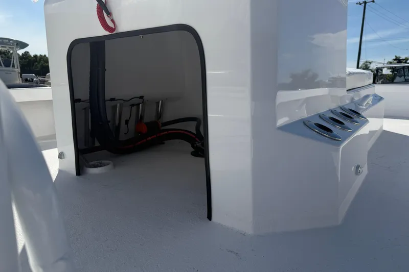 Slide: The Image of Storage compartment on a 2026 Skuta 24 Cat boat, featuring sleek design and rod holders. - 20