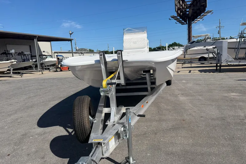Slide: The Image of 2026 Skuta 24 Cat boat on trailer in outdoor dealership lot. - 2